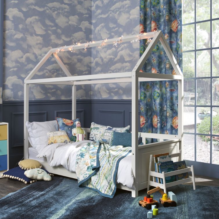 room set photo of blue themed childs room with wooden bed next to wndow with blue children's curtains fitted 