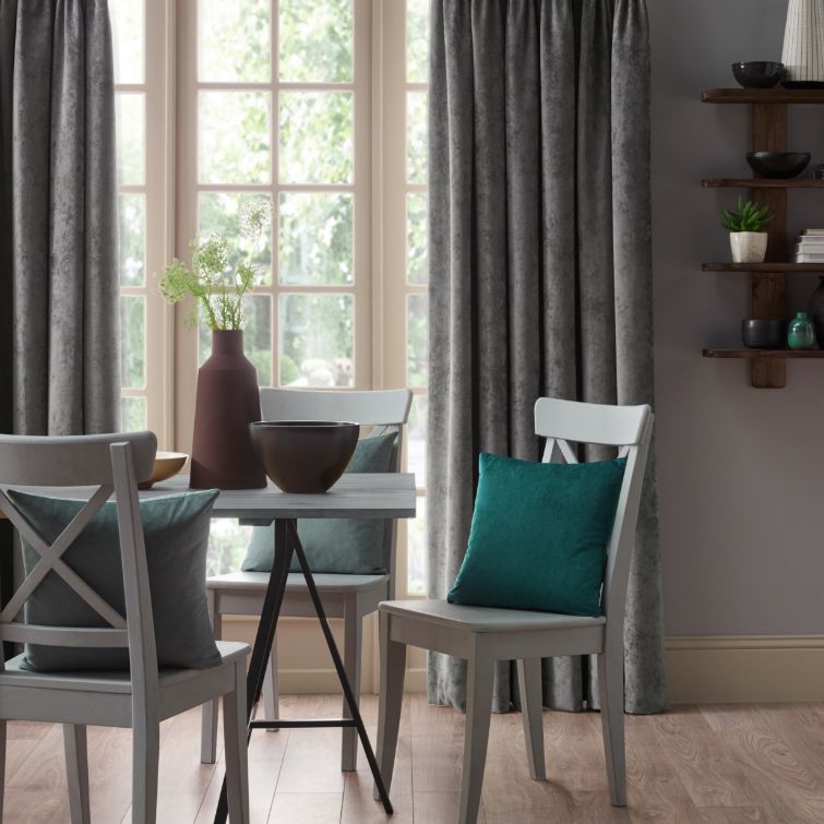image of three blue wooden chairs next to dining table infront of window and kitchen curtains 