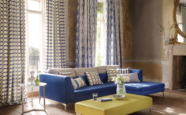 Image of blue sofa in living room next to window using living room blinds for windows