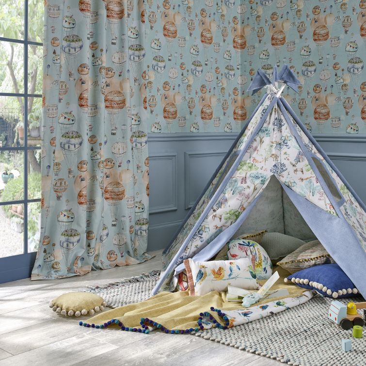 image of childs den next to nursery curtains with print that matches the wall 