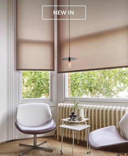 Roller Blinds in a cozy living room with a minimalist design and chairs by the window